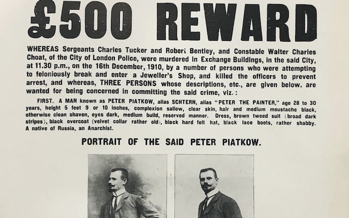 Leaflet headlined "City of London Police. Murder of Police Officers. £500 Reward", followed by descriptions of two men and one woman wanted for the killings. At centre of leaflet are two photos of a white man with a large mustache, in a dark suit, white shirt, and thin dark tie, under heading "Portrait of the Said Peter Piatkow"